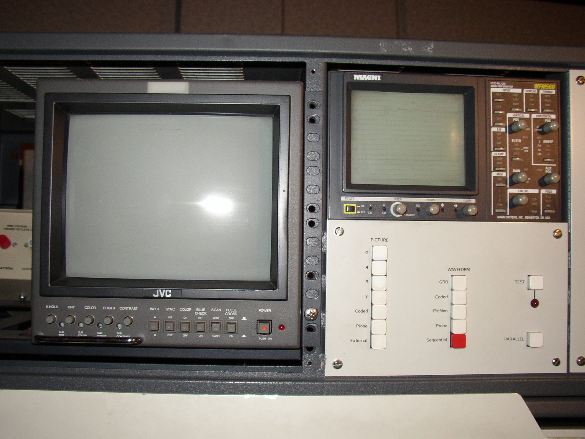 MAGNI WFM 560 NTSC/PAL/Component Analog Video waveform monitor above picture and waveform monitor switching panel.